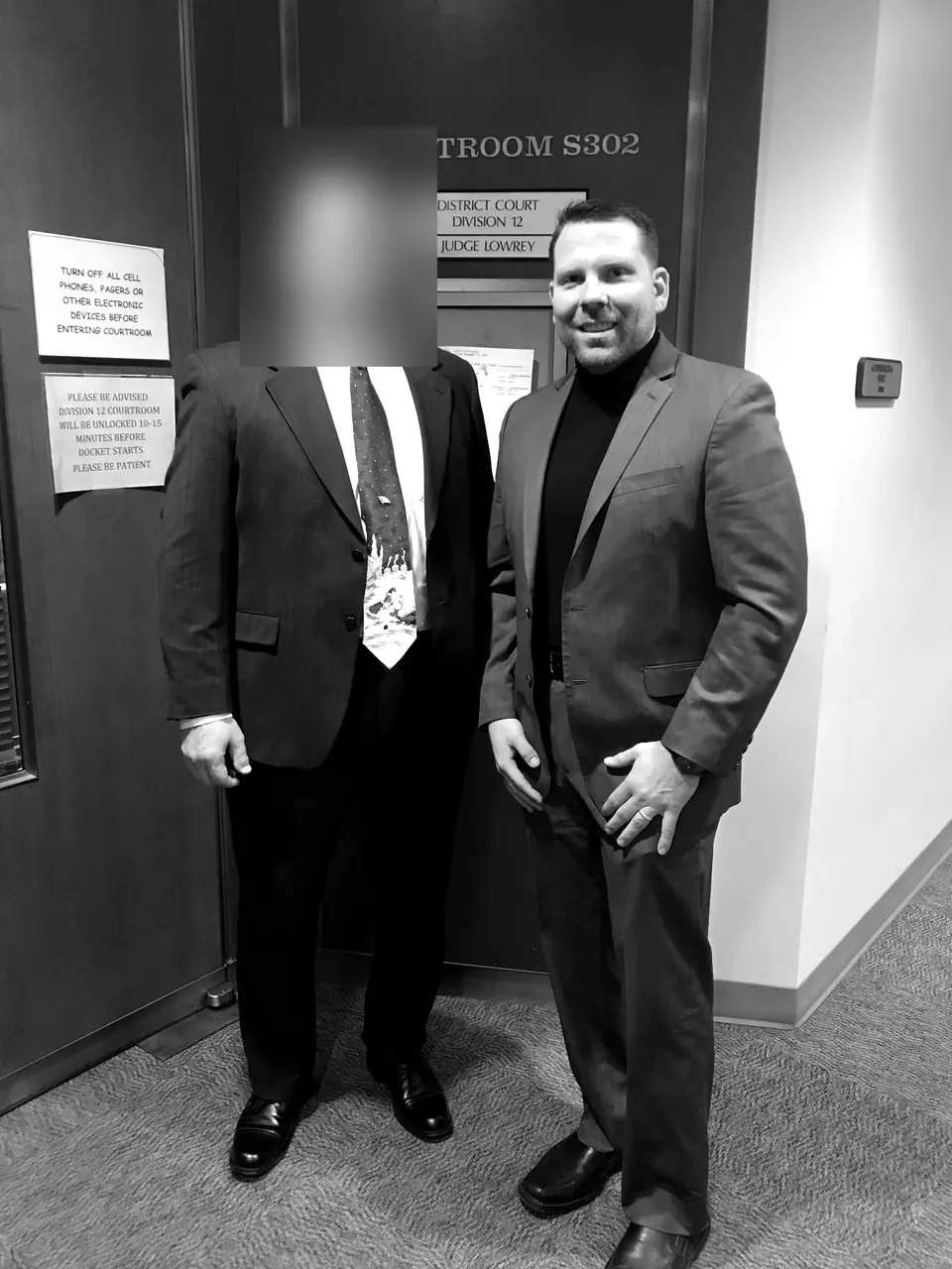 Craig Smith outside a district courtroom; other person obscured